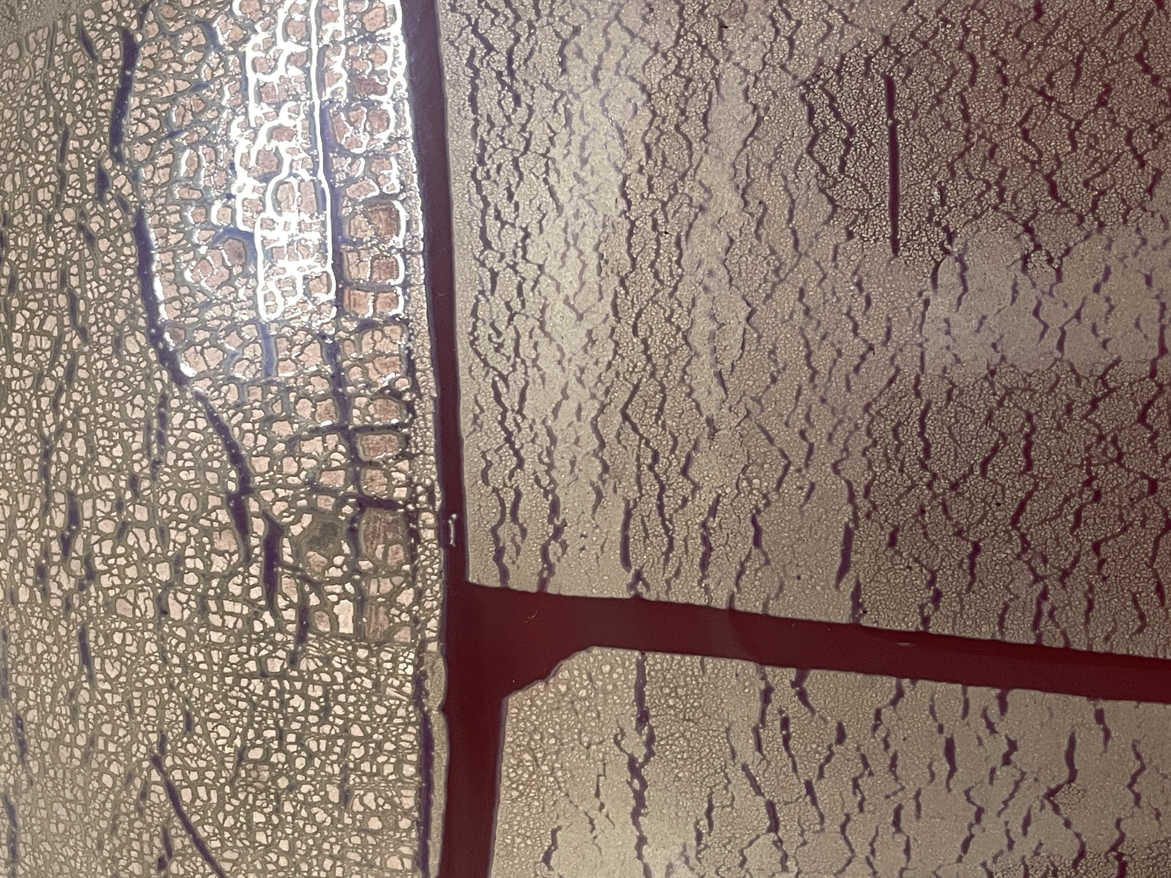 Ceramic vase. A product from a student displayed in a display case. Ceramic is very hard yet brittle, good for food/water vessels as they are also easily sanitized and cleaned. This is because once it is glaze fired it has a non-porous coating that bacteria can easily be cleaned from. Unlike non-coated ceramics which are very porous. This particular vase has layers of colour and some sort of metallic layer under the glaze as well creating an interesting aesthetic.<br>Program: Craft and Design (Ceramics) 