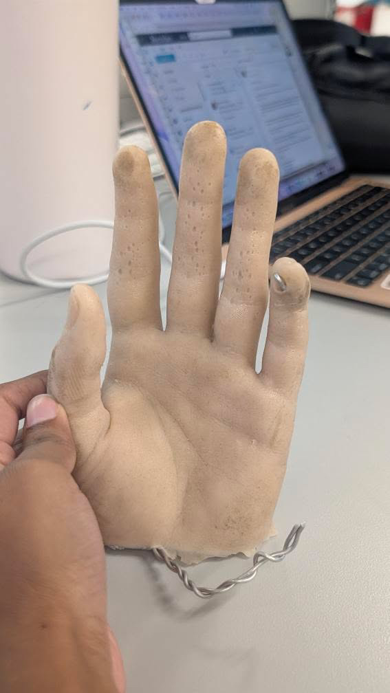 Fake hand model<br>Material state: refined<br>Colour: Beige<br>Rigidity: Low(Very plyable as intended to bend)<br>Surface Texture: Skin-like, slightly rough yet mooth and soft like dry skin.<br>Material use: Tool for form drawing or product display