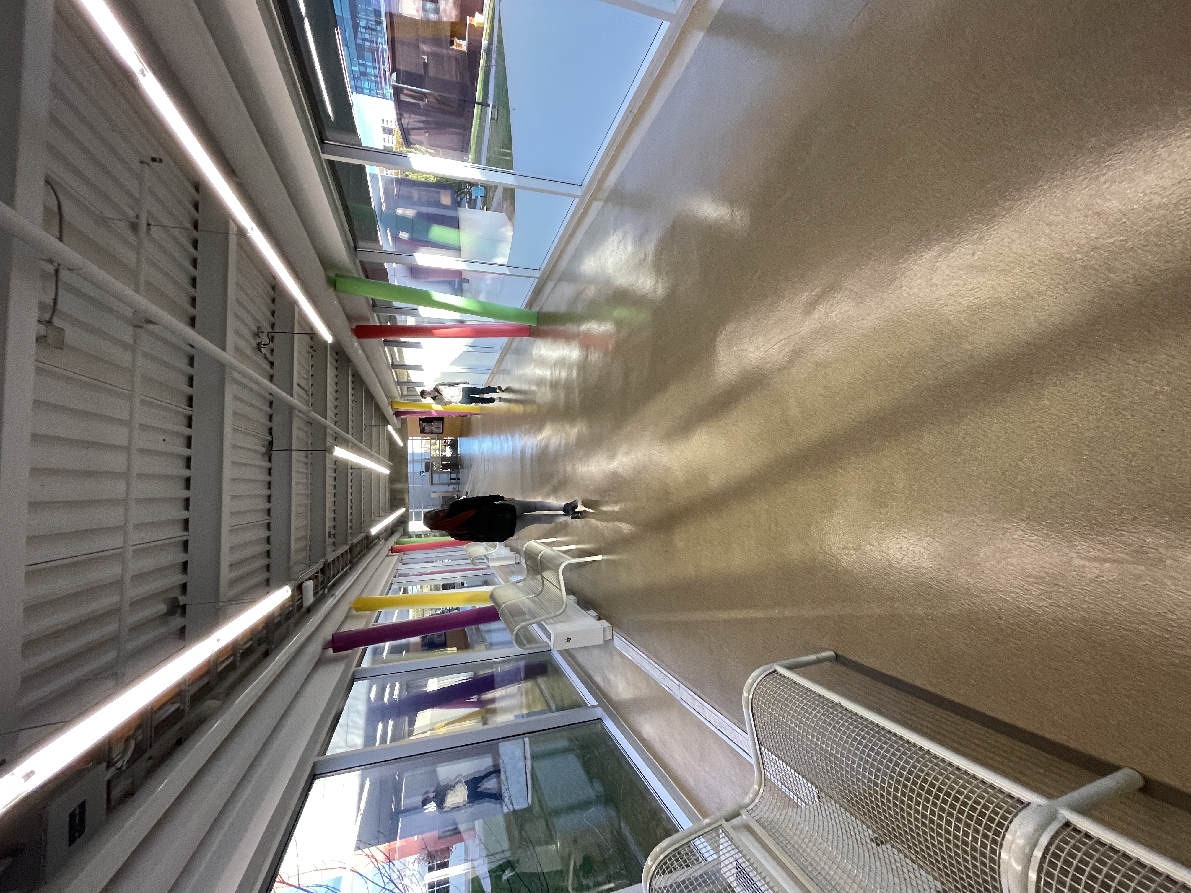 This large hallway connects the main entrance/parking lots to J wing.<br>
      It has large glass windows for light although during the winter this area becomes cold cue to the lack on insulation. There are benches for people to sit but this is mostly used to get to and from classes. 