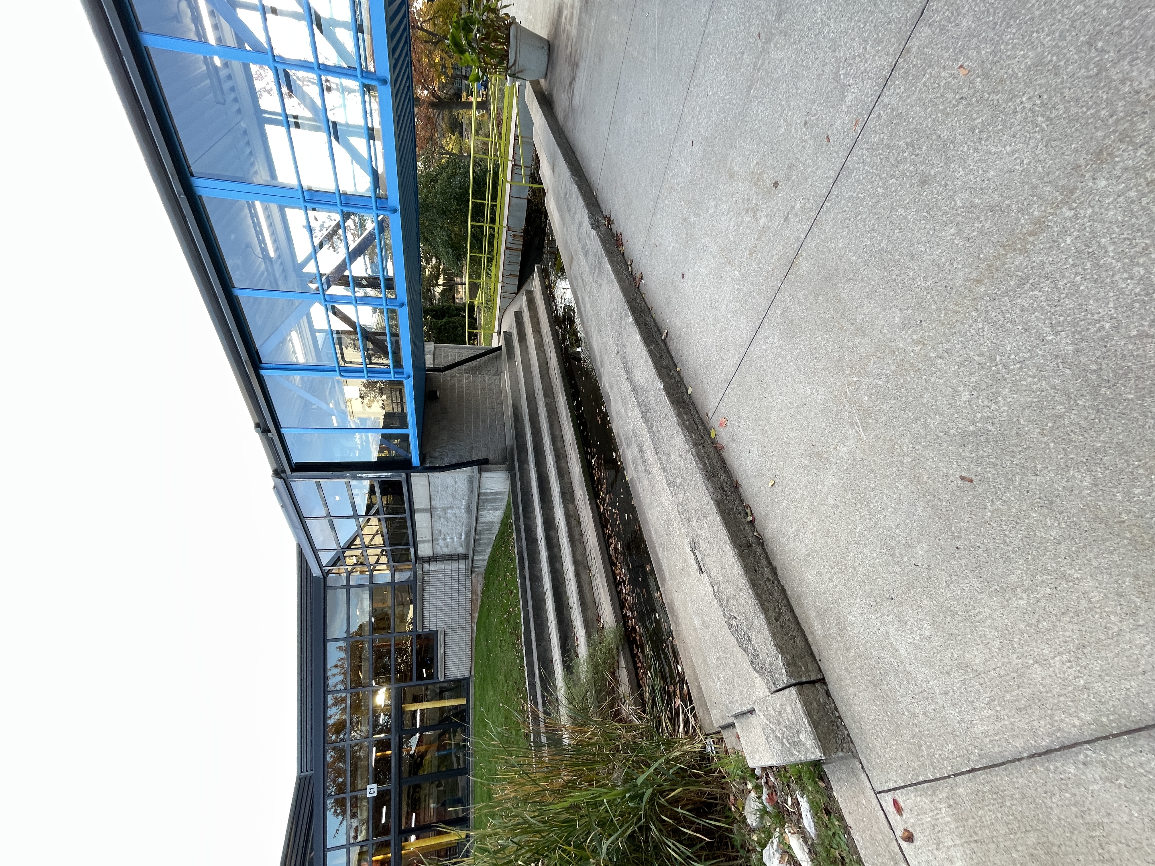 This is in the center of campus, an area where people can sit by the stream that flows through Sheridan. It is sometimes overgrown and the stream isn't always flowing well. People use this to sit by the water and hang out or eat lunch. 